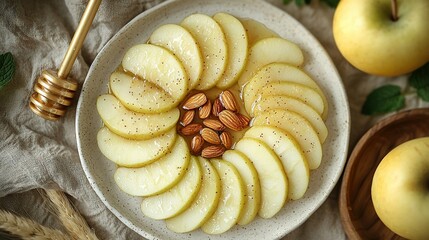 Wall Mural -   A plate of sliced apples and almonds sits next to a bowl of apples and a honey shaker