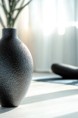 Wall Mural - A black ceramic vase sits atop a wooden table