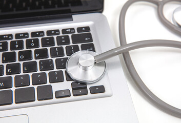 telehealth, medical stethoscope and computer laptop on white