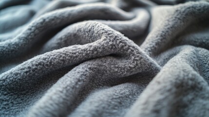 Poster - A detailed view of a cozy blanket on a bed, suitable for interior design or bedroom scene