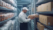 © sabyna75 - Worker organizing packaged frozen goods in industrial freezer storage