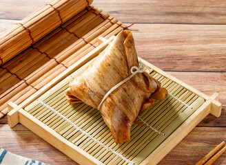 Northern Steamed Zongzi in Bamboo Leaf isolated on mat side view of taiwan food