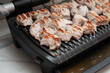 © Александр Довянский - pork is fried on a modern electric grill in the kitchen close-up