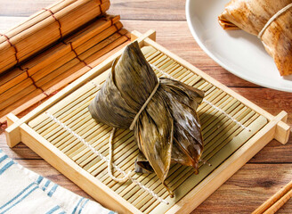 Southern Steamed Zongzi in Bamboo Leaf isolated on mat side view of taiwan food