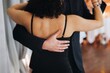 © tsuguliev - Couples dancing traditional latin argentinian dance milonga in the ballroom, tango salsa bachata kizomba lesson in red and purple lights, performance rehearsal, evening dance school class festival