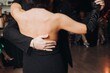 © tsuguliev - Couples dancing traditional latin argentinian dance milonga in the ballroom, tango salsa bachata kizomba lesson in red and purple lights, performance rehearsal, evening dance school class festival