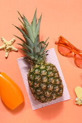 Wall Mural - Pineapple with sunscreen cream, starfish and sunglasses on red background