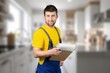 © BillionPhotos.com - Smilng young worker handyman at the kitchen