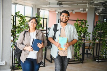 Wall Mural - Indian students, boy and girl at university with books and backpacks