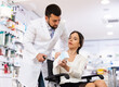 © JackF - Male pharmacist consulting disabled woman on wheelchair about medicine.