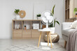 © Pixel-Shot - Electric fan on table in living room interior