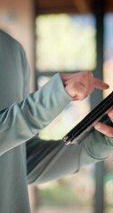 Closeup, person and fitness with tablet for typing, connection and social media for video tips. Bokeh, yogi and hands with digital for application, yoga tutorial and scroll for online information