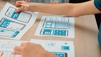 Panorama video of startup UX developer or company employee design user interface or UI prototype for mobile application or website software with software display on smartphone in office. Synergic