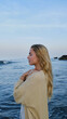 © Ivan Andriets/Stocksy - Young blonde woman meditating on the ocean shore