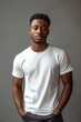 © Bijac - Basic Male Model Wearing White Blank T-Shirt Standing Against Neutral Studio Background for Apparel Mockup