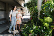 © Daniel Zapata/Stocksy - Mother and daughter observing numerous plants placed in the street.