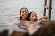© Alberto Midnight/Stocksy - Two women having fun and laughing at sunset in the Mediterranean sea
