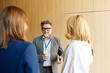 © Boris Jovanovic/Stocksy - Colleagues chat at the conference