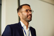 © Boris Jovanovic/Stocksy - Smiling businessman at a conference