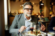 © Boris Jovanovic/Stocksy - Businessman dining at the restaurant