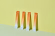 © Marc Tran/Stocksy - Three vibrant orange citrus stick packs are displayed against a yellow