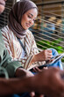 © Jovo Jovanovic/Stocksy - Female professional using digital tablet while sitting with coworker