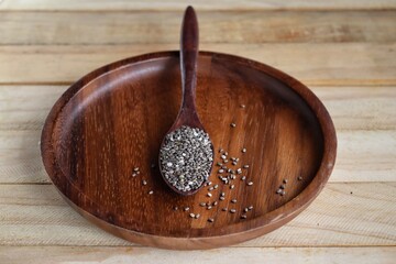 Wall Mural - Chia seeds on brown wood background