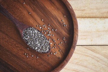 Wall Mural - Chia seeds on brown wood background