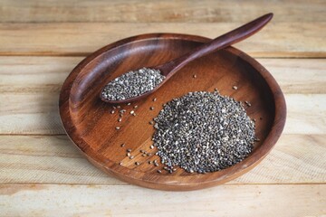 Wall Mural - Chia seeds on brown wood background