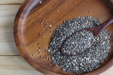 Wall Mural - Chia seeds on brown wood background