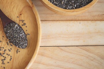 Wall Mural - Chia seeds on brown wood background