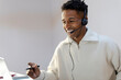 © Jimena Roquero/Stocksy - Smiling Customer service agent in call center using headset