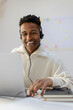 © Jimena Roquero/Stocksy - Smiling man in customer service office attending call