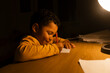 © Jelena Markovic/Stocksy - Kid drawing in the room under the lamp
