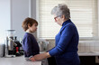 © Nasos Zovoilis/Stocksy - Grandmother interacts with her grandson in a modern kitchen