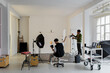 © BONNINSTUDIO/Stocksy - Photographers working in professional studio with lighting equipment
