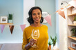 © Santi Nuñez/Stocksy - Smiling guest holding a wine glass at festive celebration
