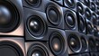 © chusnul - Close-up view of an array of black speakers arranged in a wall configuration, showcasing sound technology