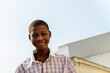 © Anna Fedorova/Stocksy - Smiling african teenager urban portrait outdoors
