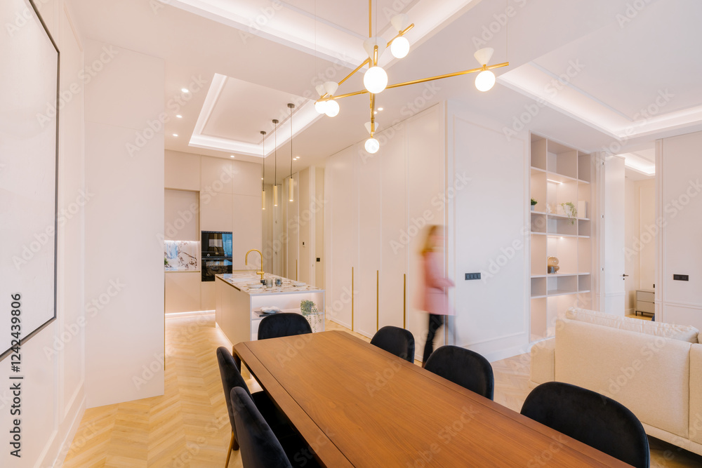 Modern open-concept kitchen and dining area with warm lighting Stock ...