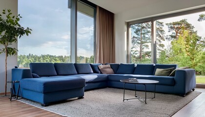 Wall Mural - Mordern living room with big tree windows and dark blue corner sofa. Modern living room with sofa. 