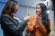 © amnaj - Two businesswomen showing appreciation and gratitude in the office