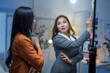 © amnaj - Asian businesswomen discussing strategy and writing on whiteboard in office meeting