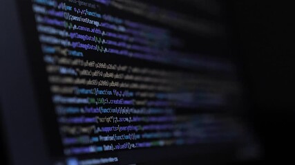 Wall Mural - developer is browsing html code on the computer screen. side view. html web page code scrolling prog