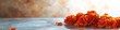 © BerkahStock - Orange marigold flowers on a gray surface with blurred background.