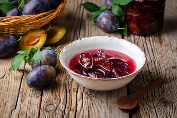 Wall Mural - Homemade damson plum jam in blue ceramic bowl and berries