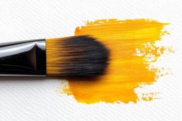 Aufkleber - Creating vibrant artwork with a brush loaded with bright yellow paint on textured paper