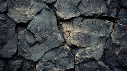 Poster - Dark grey stone wall with rough texture forming a natural background