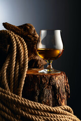 Wall Mural - Brandy snifter and rope on a old stumb.