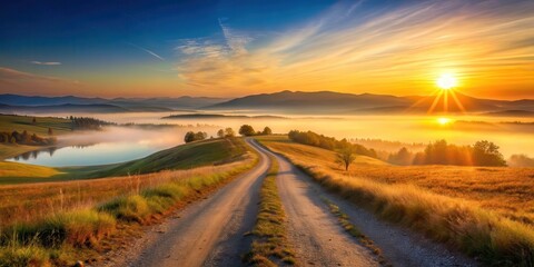 Wall Mural - Serene sunrise over a misty valley, winding road leading to distant hills, golden hour landscape with tranquil lake